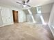 Spacious bedroom with neutral carpeting, multiple windows, and a ceiling fan at 8116 Reynard Rd, Chapel Hill, NC 27516