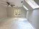 Well-lit room featuring skylights, a ceiling fan, and a large window at 8116 Reynard Rd, Chapel Hill, NC 27516