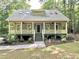 Charming cottage style home with a welcoming front porch and landscaped yard at 8116 Reynard Rd, Chapel Hill, NC 27516