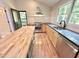 Updated kitchen with butcher block island and stainless appliances at 8116 Reynard Rd, Chapel Hill, NC 27516