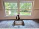 Kitchen sink with double windows that overlook the treed backyard at 8116 Reynard Rd, Chapel Hill, NC 27516