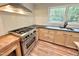 Well appointed kitchen with granite countertops, subway tile, and stainless appliances at 8116 Reynard Rd, Chapel Hill, NC 27516