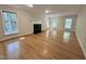 Spacious living room features hardwood floors, fireplace, and many windows for natural light at 8116 Reynard Rd, Chapel Hill, NC 27516