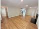 Living room has hardwood floors, fireplace, staircase, and flows into other rooms at 8116 Reynard Rd, Chapel Hill, NC 27516