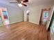 Main bedroom features hardwood floors, ceiling fan and view into other rooms at 8116 Reynard Rd, Chapel Hill, NC 27516