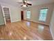 Main bedroom with ceiling fan, windows, and hardwood floors has access to closet and other rooms at 8116 Reynard Rd, Chapel Hill, NC 27516