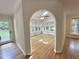 View from the kitchen into the bright sunroom with many windows and vaulted ceiling at 8116 Reynard Rd, Chapel Hill, NC 27516