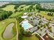 Expansive community featuring a golf course, pool, clubhouse, and lush green landscape at 821 Rambling Oaks Ln, Holly Springs, NC 27540