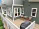 Back deck with seating area and grill with view of private backyard at 821 Rambling Oaks Ln, Holly Springs, NC 27540
