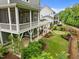 Backyard view of screened porch, patios, putting green, and landscaped yard at 821 Rambling Oaks Ln, Holly Springs, NC 27540