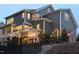Beautiful backyard featuring a multi-level deck and charming string lights for evening ambiance at 821 Rambling Oaks Ln, Holly Springs, NC 27540