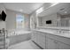 Bright bathroom with a soaking tub, white marble, double vanity, and a large mirror at 821 Rambling Oaks Ln, Holly Springs, NC 27540