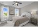 Cozy bedroom with neutral tones, natural light, and comfortable furnishings, including ceiling fan at 821 Rambling Oaks Ln, Holly Springs, NC 27540