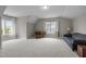 Spacious bonus room with ample natural light and neutral carpet, providing a versatile living area at 821 Rambling Oaks Ln, Holly Springs, NC 27540