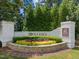 Welcoming entrance to The 12 Oaks Club featuring beautiful landscaping at 821 Rambling Oaks Ln, Holly Springs, NC 27540