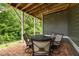Covered patio with brick flooring and outdoor dining area for entertaining at 821 Rambling Oaks Ln, Holly Springs, NC 27540