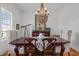 Elegant dining room with wood table, chandelier, and decorative mirror, perfect for entertaining guests at 821 Rambling Oaks Ln, Holly Springs, NC 27540