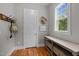 Inviting entryway with hardwood floors, coat rack, decorative hat, console table, and natural light at 821 Rambling Oaks Ln, Holly Springs, NC 27540