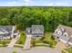 Attractive two-story home with a welcoming front porch and well-manicured lawn at 821 Rambling Oaks Ln, Holly Springs, NC 27540