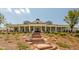 Elegant clubhouse featuring brick stairs, stone accents and a sprawling covered porch at 821 Rambling Oaks Ln, Holly Springs, NC 27540