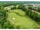 Aerial shot showcasing the golf course layout with manicured greens and surrounding residential community at 821 Rambling Oaks Ln, Holly Springs, NC 27540