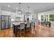 Modern kitchen with a large island, stainless steel appliances, pendant lighting, and an open layout at 821 Rambling Oaks Ln, Holly Springs, NC 27540