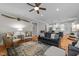 Comfortable living room with hardwood floors, ceiling fan, and view of the kitchen at 821 Rambling Oaks Ln, Holly Springs, NC 27540