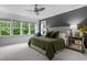Spacious main bedroom with natural light, modern decor, and a cozy seating area by the window at 821 Rambling Oaks Ln, Holly Springs, NC 27540