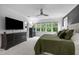 Bright main bedroom featuring natural light, sleek furniture, and ample space for relaxation at 821 Rambling Oaks Ln, Holly Springs, NC 27540