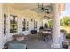 Picturesque outdoor seating area with ceiling fans and beautiful light-blue paneled ceilings at 821 Rambling Oaks Ln, Holly Springs, NC 27540
