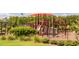 A colorful playground with swings, slides, and climbing structures, surrounded by lush greenery at 821 Rambling Oaks Ln, Holly Springs, NC 27540