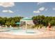 Interactive pool with a splash fountain, slide, and lifeguard on duty for safety at 821 Rambling Oaks Ln, Holly Springs, NC 27540