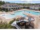 Resort-style pool area with a waterslide, splash pad, and plenty of lounge chairs at 821 Rambling Oaks Ln, Holly Springs, NC 27540