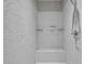 Modern, tiled shower with a built-in seat and mounted shower products at 821 Rambling Oaks Ln, Holly Springs, NC 27540