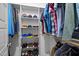 Organized walk-in closet with shelving, rods, and space for shoes, providing convenient storage solutions at 821 Rambling Oaks Ln, Holly Springs, NC 27540