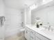 Clean, well-lit bathroom with dual sinks, sleek white countertops, and a combined tub and shower featuring white tile at 8763 Wardle Ct, Wake Forest, NC 27587