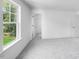 Bedroom with large window offering lots of natural light, ensuite bathroom, and closet at 8763 Wardle Ct, Wake Forest, NC 27587