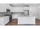 Bright kitchen boasts white cabinets, stainless appliances, large island, and stylish backsplash at 8763 Wardle Ct, Wake Forest, NC 27587