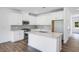 Bright kitchen boasts white cabinets, stainless appliances, large island, and stylish backsplash at 8763 Wardle Ct, Wake Forest, NC 27587