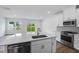 Modern kitchen with stainless steel appliances, island, white cabinets, and eat-in breakfast area at 8763 Wardle Ct, Wake Forest, NC 27587