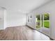 Living room featuring hardwood floors and a glass sliding door to the patio at 8763 Wardle Ct, Wake Forest, NC 27587