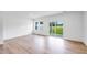 Open living room area with hardwood floors, large windows and glass sliding doors at 8763 Wardle Ct, Wake Forest, NC 27587
