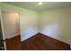 Bright bedroom with beautiful hardwood floors and ample natural light from the window at 902 Roanoke Ave, Henderson, NC 27536