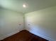 Bedroom with hardwood flooring and white trim; ready to be personalized at 902 Roanoke Ave, Henderson, NC 27536