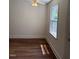 Bright bedroom with hardwood floors, ceiling fan, and natural light at 902 Roanoke Ave, Henderson, NC 27536
