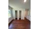 Bedroom featuring hardwood floors, closets, and natural light from the windows at 902 Roanoke Ave, Henderson, NC 27536