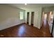 Bedroom featuring hardwood floors, a closet, and natural light from the window at 902 Roanoke Ave, Henderson, NC 27536