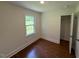 Bedroom featuring a closet, window, and hardwood floors at 902 Roanoke Ave, Henderson, NC 27536