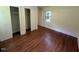 Bedroom featuring hardwood floors, a closet, and natural light from the window at 902 Roanoke Ave, Henderson, NC 27536