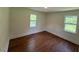 Bedroom featuring hardwood floors and natural light from the two windows at 902 Roanoke Ave, Henderson, NC 27536